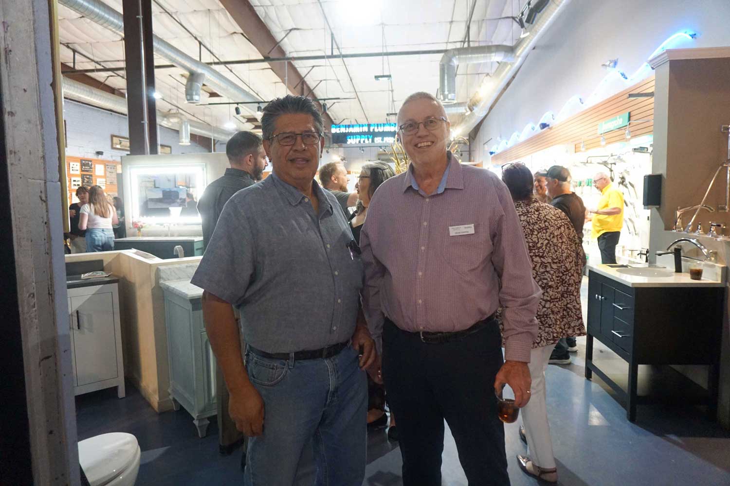 Two men smiling and posing together at the event.