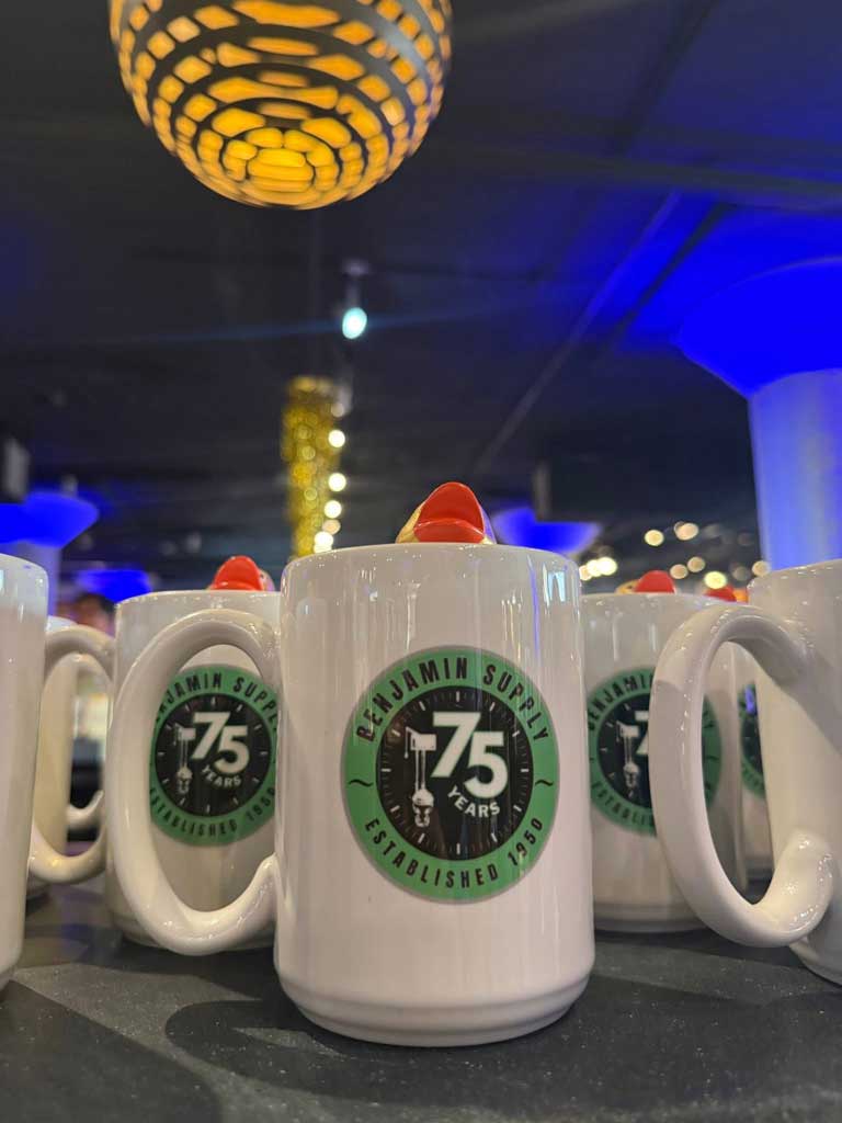Close-up of commemorative 75th Anniversary mugs with rubber ducks inside.
