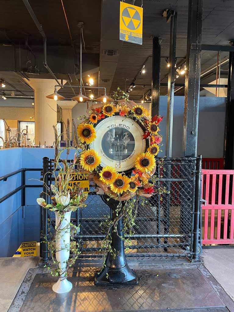 Close-up of the sunflower wreath on the vintage Toledo scale.