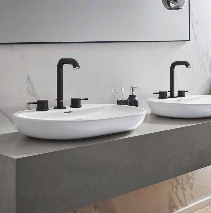 Two matte black faucets and two sinks