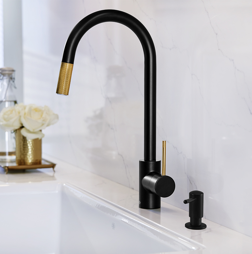 Matte black kitchen faucet with a touch of brass and a soap dispenser