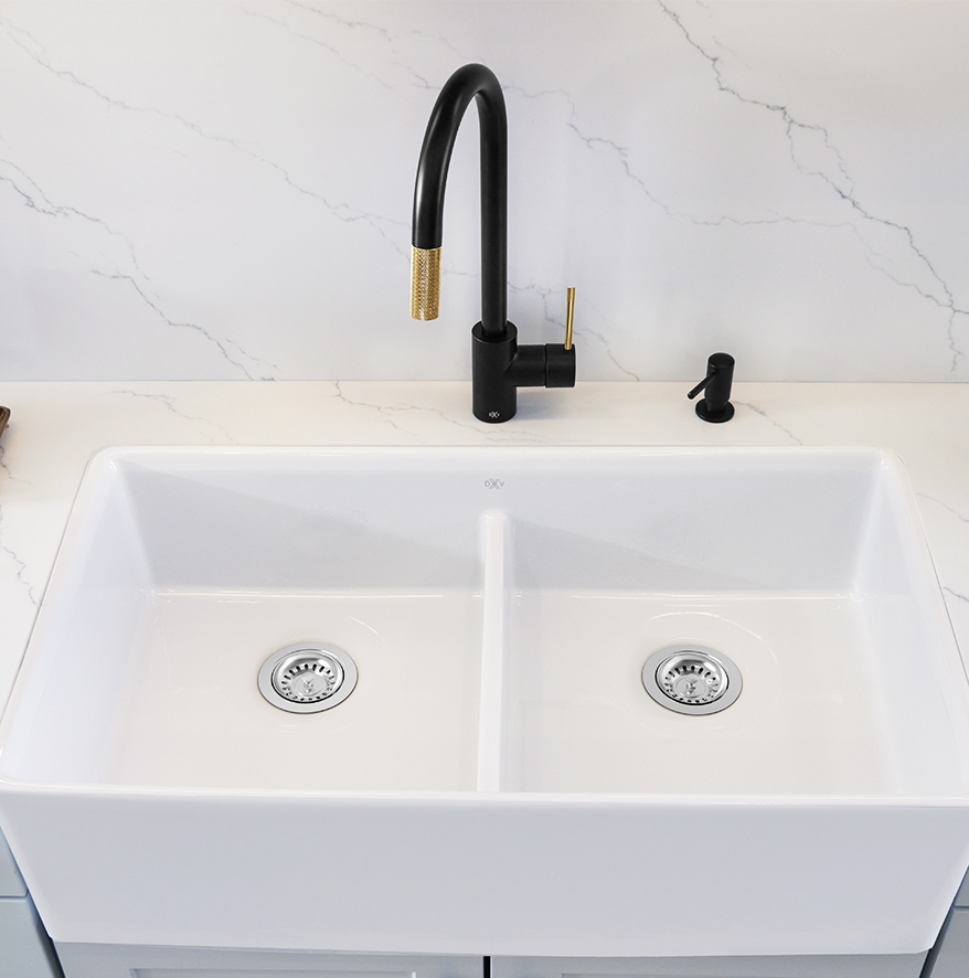 A sink, a faucet and a soap dispenser