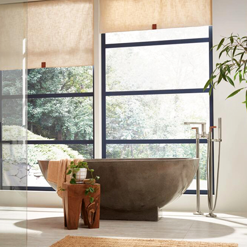 Freestanding concrete bathtub with faucets from the FRANK LLOYD WRIGHT® collection by BrizoMD in Brilliance® Luxe Nickel® / Wood finish