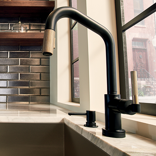 Brizo® Litze® collection kitchen faucet in a matte black gold finish and Brizo® Solna® soap dispenser