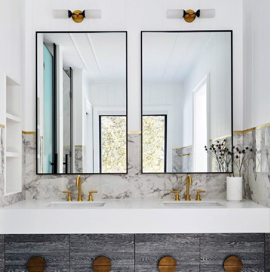 A bathroom with two vanities and two mirrors
