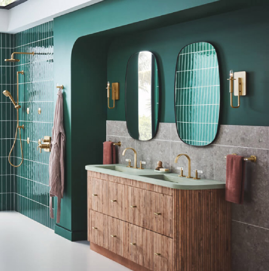 A green bathroom with two vanities and two mirrors