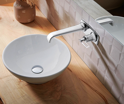 Wall-mount sink faucet in the Allaria® de BrizoMD with lever handles installed on the wall, Chrome poli / transparent