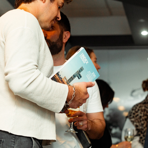 Personne ayant le guide des 200 adresses d’Index Design dans les mains.
