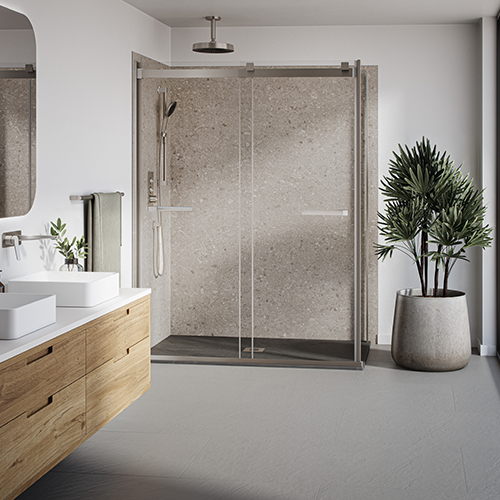 A beige shower space with chrome Kalia faucets.