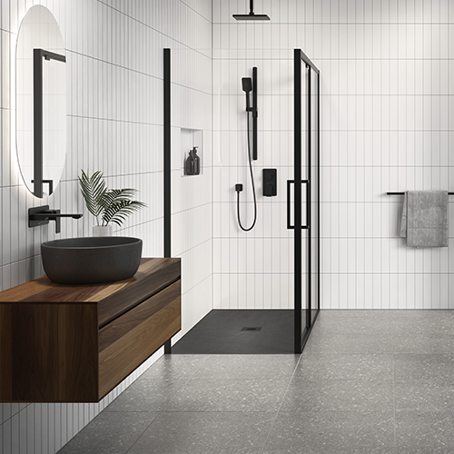 A shower space with black Kalia faucets.