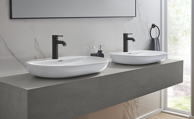 Two sinks in a bathroom with faucets