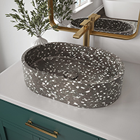 Textured vessel sink with a gold faucet in a bathroom