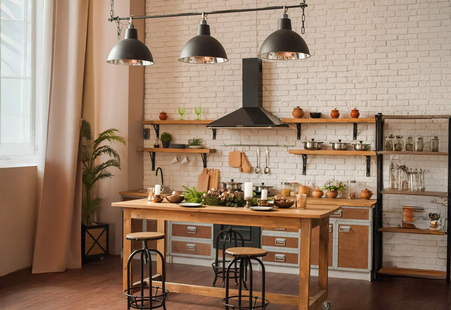 A kitchen featuring a wooden table, four chairs, and a stove against a light-colored wall.