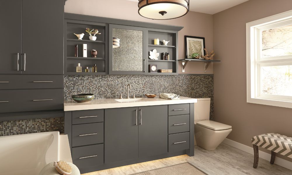 Bathroom with dark grey shaker cabinets, a mosaic tile backsplash, and a white countertop.