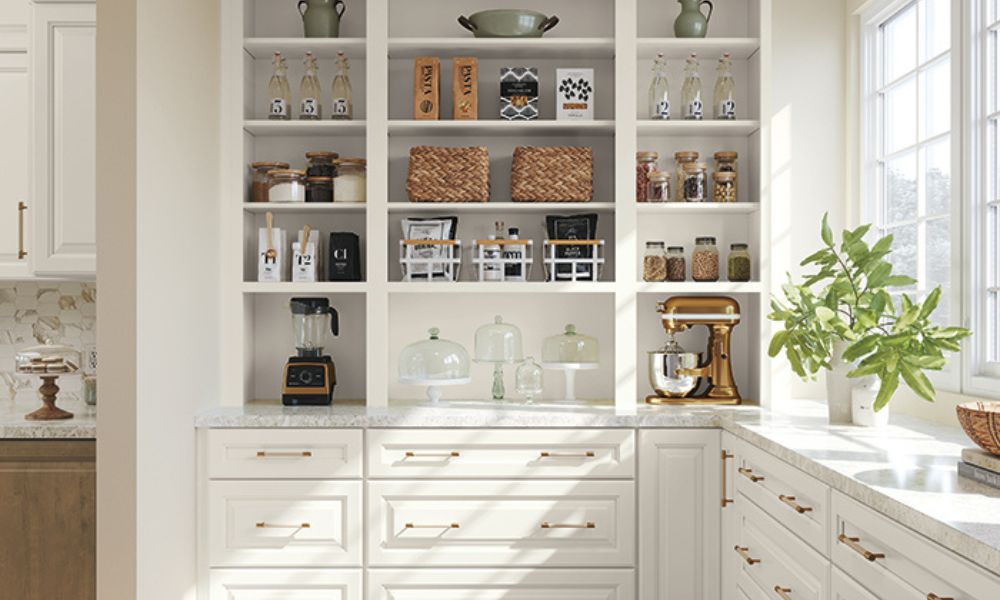 Pantry with white shaker cabinets, open shelving, and gold hardware.