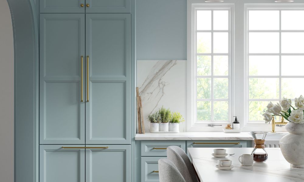 A modern kitchen featuring blue cabinets complemented by elegant gold accents.