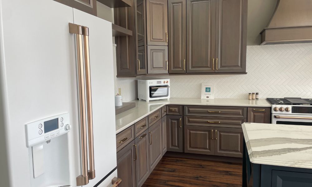 A kitchen featuring dark wood cabinets paired with white appliances, creating a modern and elegant atmosphere.