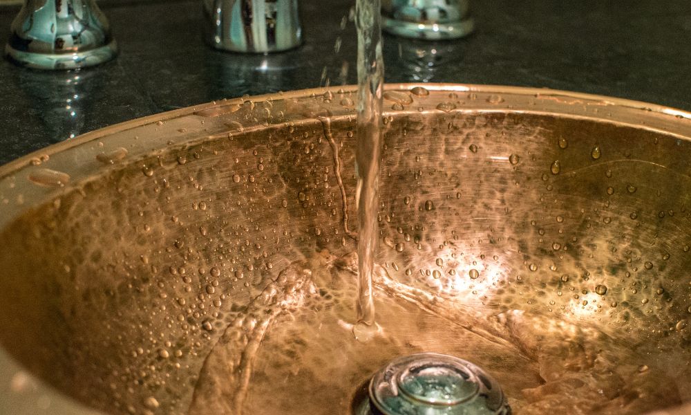 Hammered copper sink with flowing water