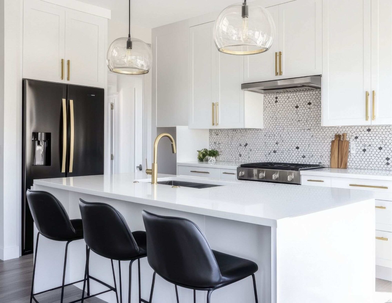 White modern kitchen with black bar stools at an island.