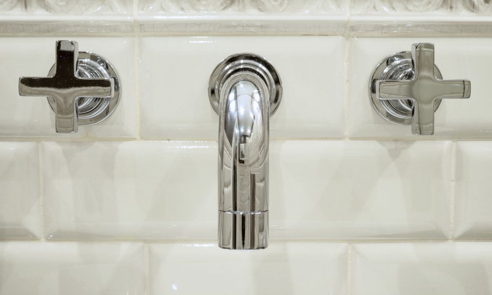 Wall-mounted chrome faucet on subway tile