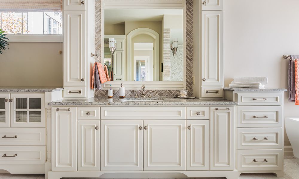 Large white built-in bathroom cabinetry with ample storage