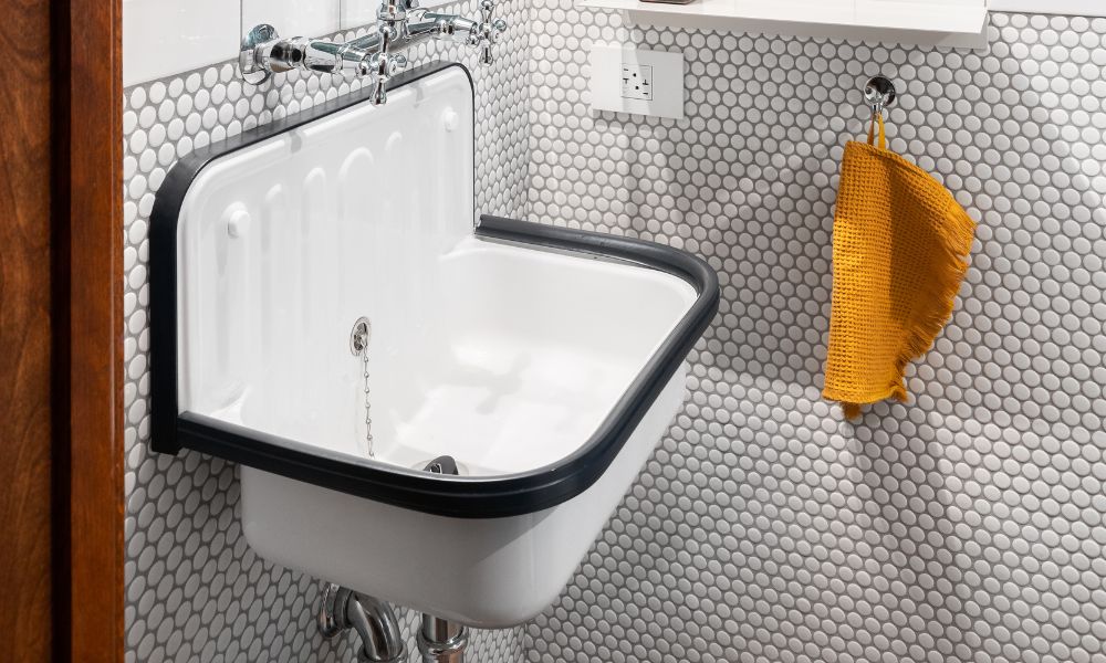 White bucket-style wall-mounted sink with black rim