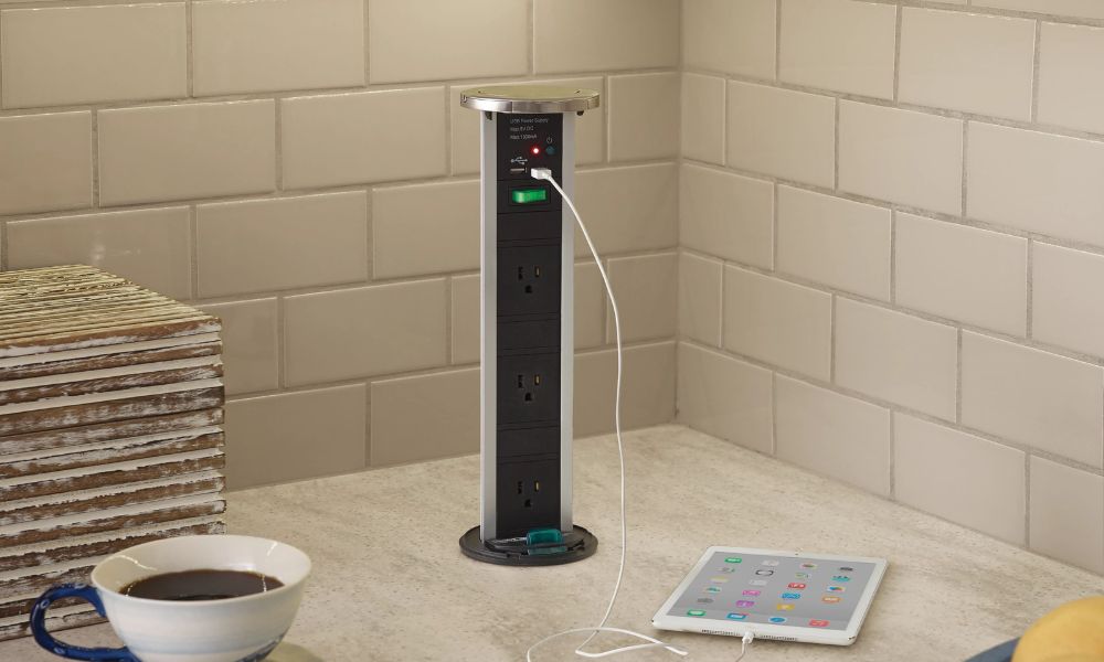 A pop-up Power Pod outlet installed in a kitchen countertop featuring electrical sockets and USB ports