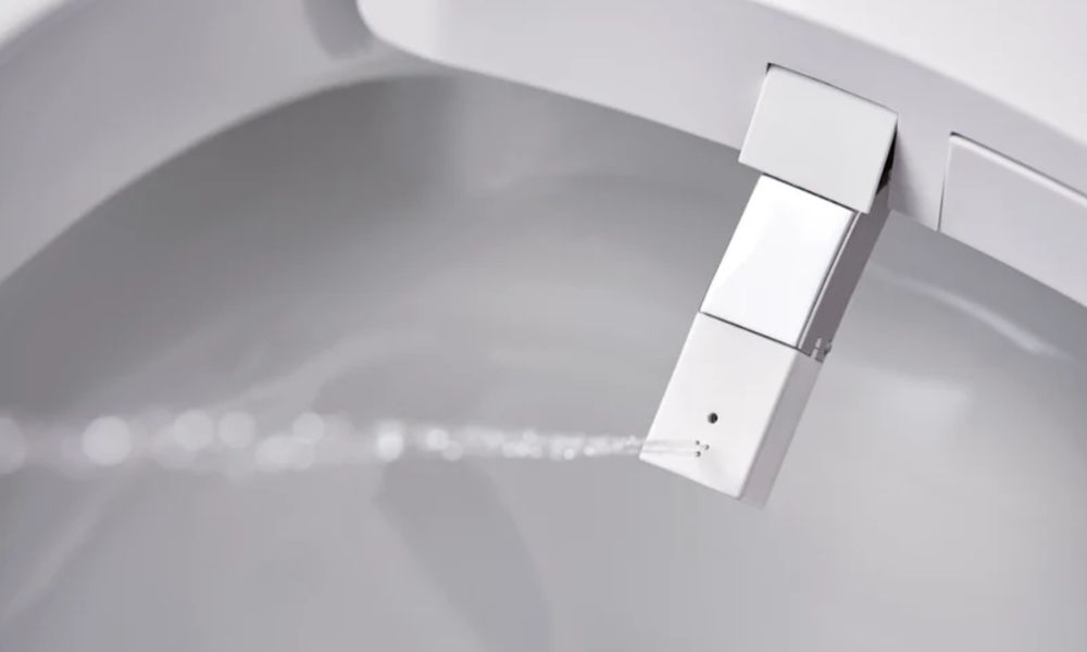 A close up of a modern bidet sprayer.