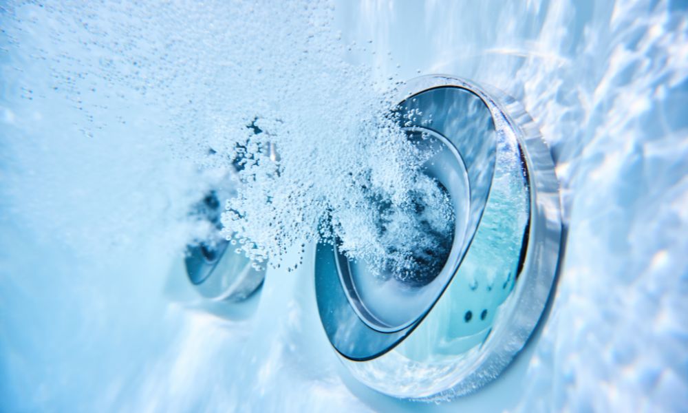A high-power hydro-jet in a whirlpool tub creating therapeutic bubbles.