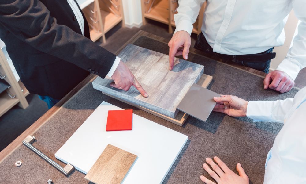 A DKB showroom consultant and client examining an open kitchen drawer during a showroom visit