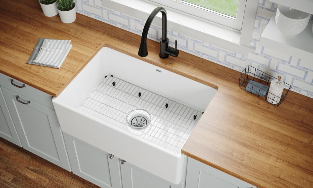 A kitchen sink with a window above it, set on a wooden counter, showcasing a bright and inviting cooking space.