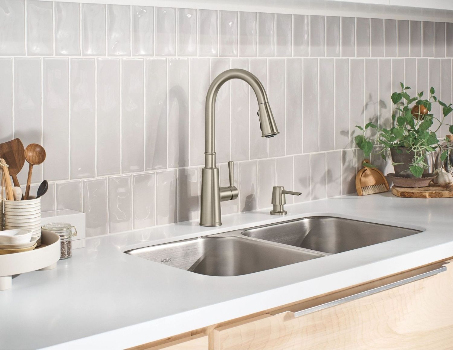 A modern kitchen sink featuring a stainless steel faucet, showcasing a clean and functional design.