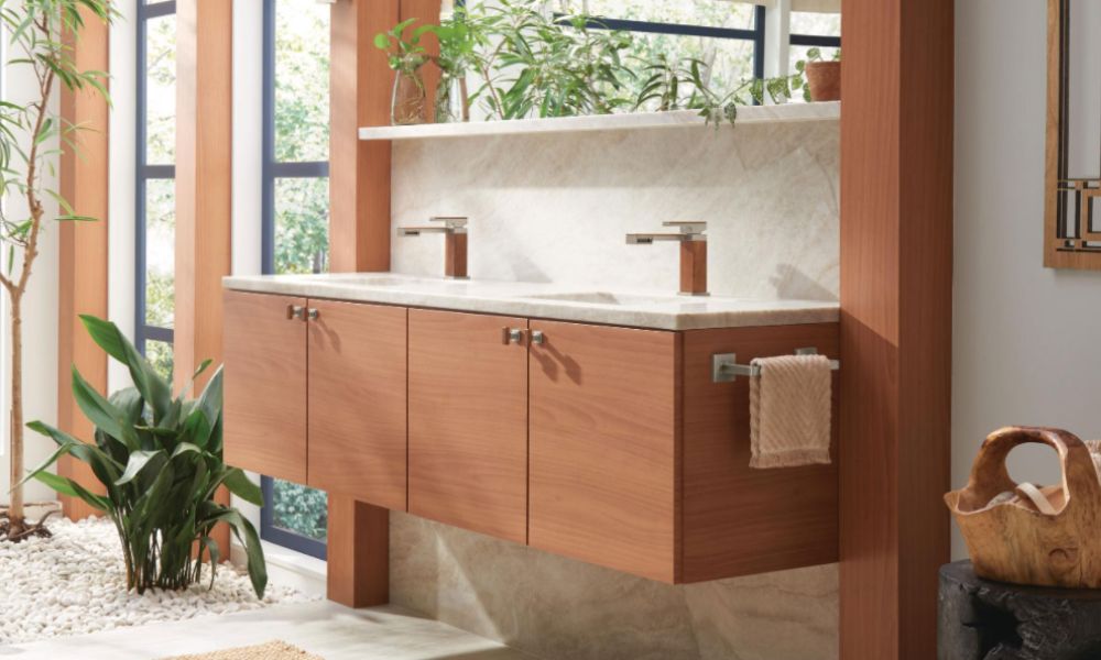 A bathroom featuring a wooden vanity and a green plant, creating a natural and inviting atmosphere.
