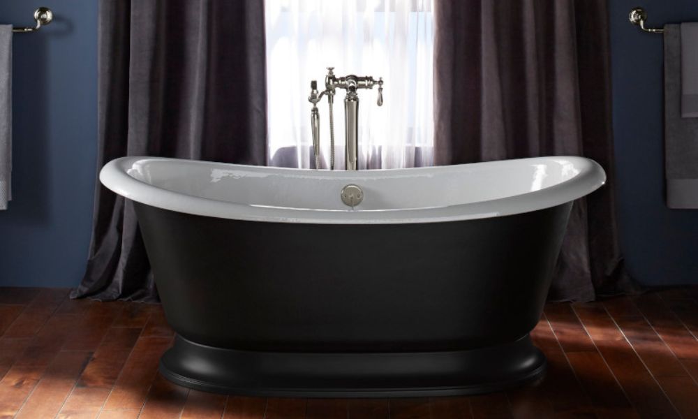 A black and white bathtub positioned in a stylish bathroom setting, showcasing modern design elements.